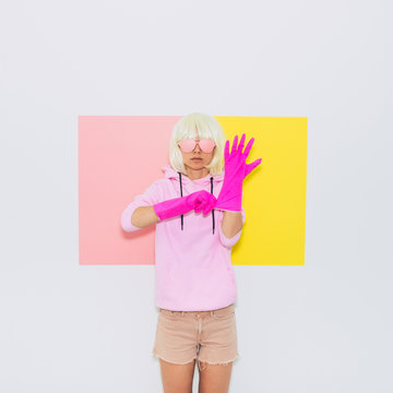 Doll Blonde Girl Model in Fashion accessory sunglasses, gloves,  hoodie and shorts.  Mood and vibes. Minimal unicorn style. Pink and yellow neon colors. 90s or 80s
