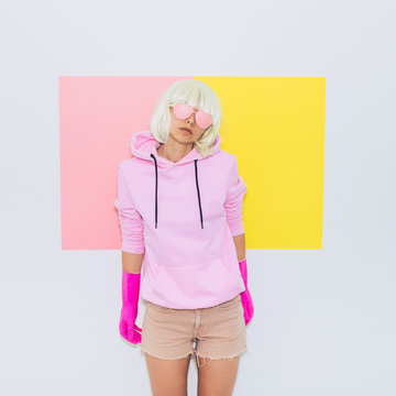 Blonde Girl Model with beauty face in Fashion accessory sunglasses, gloves,  hoodie and shorts. Club DJ Party Fun. Mood and vibes. Minimal unicorn style. Pink and yellow neon colors. 90s or 80s