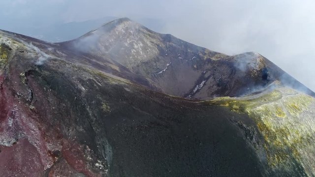 Aerial moving towards Mount Etna peak an active volcano on east coast Sicily is highest active volcano in Europe and one of most active volcanoes in world in almost constant state of activity 4k