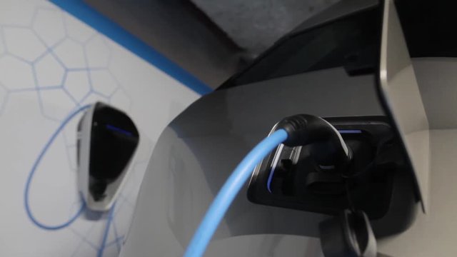 Close up footage of the power socket of an electric car, charging.