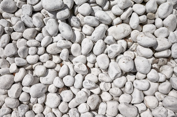 Top view of naturally polished white pebbles