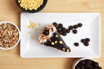 Milk and chocolate cake with chocolate ball and crispy