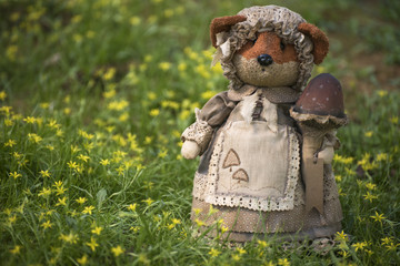 Fox toy in the meadow with yellow flowers.