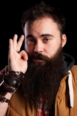 Close up portrait of bearded hipster man on black background