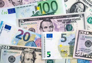 Fototapeta na wymiar Euro and US dollar banknotes mixed. Euro dollar exchange rate
