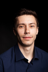 Fototapeta premium Fashion portrat of young man on black background in studio photo