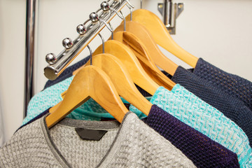 Men's sweaters at  shop window. Sale of fashionable men's clothing_