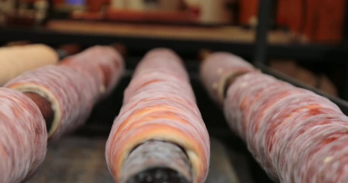 Hungarian cinnamon chimney cake sweet dessert being cooked grilled prepared on the street2
