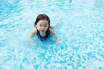 Portrait of Asian little baby girl playing in swimming pool