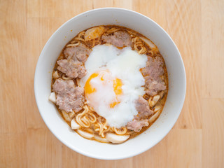 Top view of instant noodle with soft boiled egg and pork.