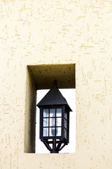 Street lamp in niche of wall.