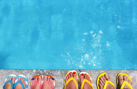 Feet In Flip Flops On Stone Background