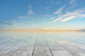 Empty square floor tiles and beautiful sky landscape
