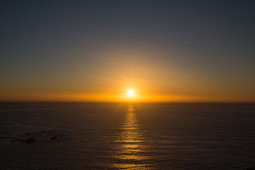 Golden sunset over the ocean with reflection