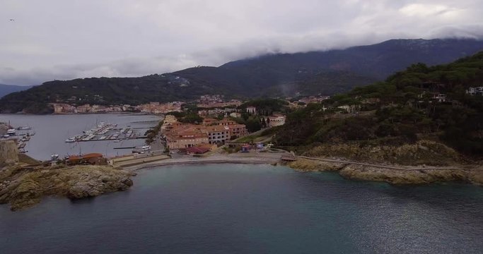 Aerial, beautiful bay and a little port of Marciana Marina on Elba island in Tuscany, Italy on a cloudy day