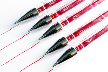 five traces of red paste from red pens on white paper, red lines on paper