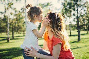 Mother hugs her dauhter.