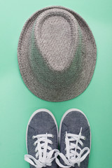 Woman's flat lay clothes gray hat and gray sneakers