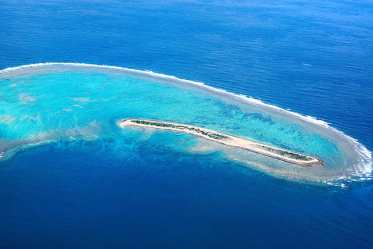 Aerial view over the tropical resort island of Nagannu in Okinawa, Japan surrounded by beautiful turqoise water