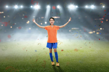 Fototapeta na wymiar Happy asian female soccer player celebrate