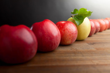 Fototapeta na wymiar Ripe juicy apples on a wooden table.