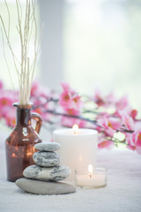 Fototapeta na wymiar Spa accessories still life with aromatic candle, stone, flower, towel.