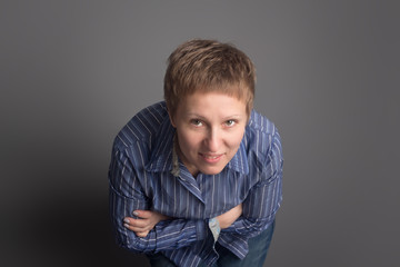 Obraz premium Happy smiling middle-aged woman in blue shirt