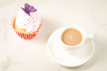 cappuccino white cup and fresh cake with butterfly/cappuccino white cup and fresh cake with butterfly on a white marble background. Top view