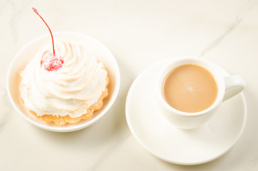 cappuccino white cup and fresh cake with cherry/cappuccino white cup and fresh cake with cherry on a white marble background. Top view