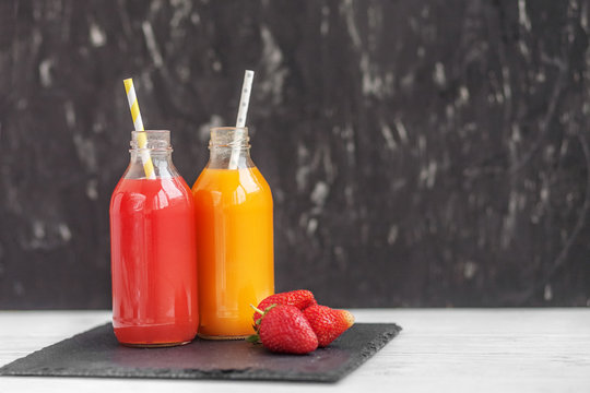 Multivitamin and strawberry juice in glass bottles. The concept of beverages, health food and vegetarian.