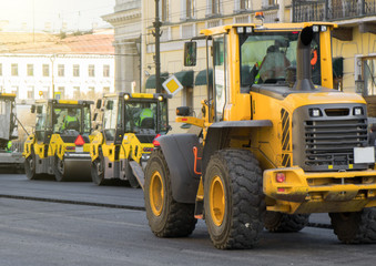 Road re-construction. Road rollers stacking hot asphalt.