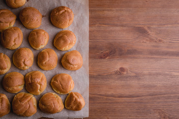 fresh eclairs on parchment wooden table