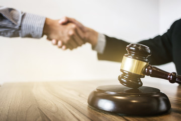 tribunal and justice concept  Consultation with insurance lawyer hand shaking