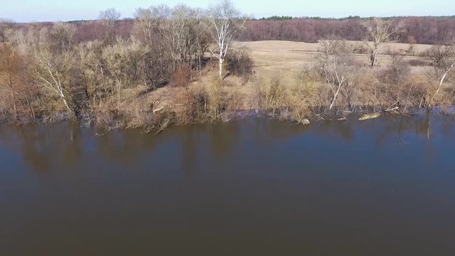 FLIGHT OVER RIVER BY MEADOW AND FOREST. THE RIVER OF PSEL, UKRAINE. EARLY SPRING, APRIL.