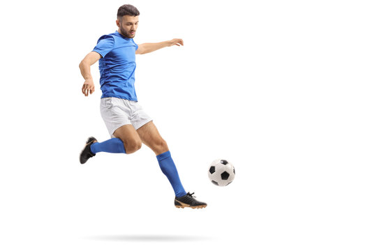 Fototapeta Soccer player in mid-air kicking a football