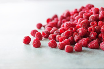 Fresh organic raspberries. Fruit background with copy space. Summer and berries harvest concept. Vegan, vegetarian, raw food.