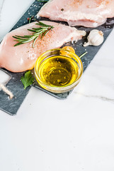 Raw chicken breast filet meat with spices and olive oil top view copy space