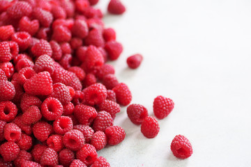 Fresh organic raspberries. Fruit background with copy space. Summer and berries harvest concept. Vegan, vegetarian, raw food.