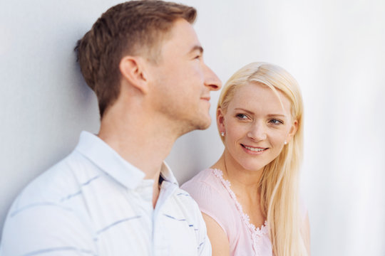 Attractive young blond woman watching her husband