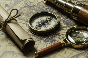 Retro compass with old map and spyglass