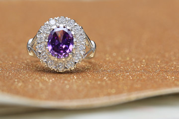 purple gemstone on diamond ring