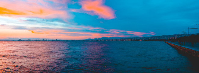 Fototapeta na wymiar Panoramic sunset view over ocean and city beach