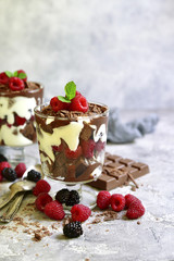 No baked brownie cheesecake with fresh berries in a glass.