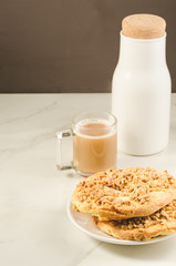 Coffee break with fresh dry biscuit with nuts and bottle milk/ Coffee break with fresh dry biscuit with nuts and bottle milk. Selective focus and copyspace