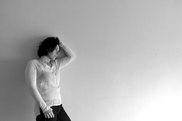 woman who is sad standing and slammed into the wall