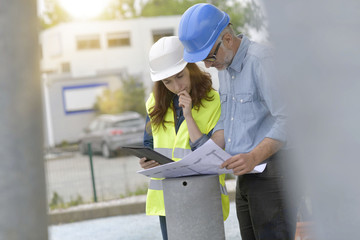 Construction engineers meeting outside building