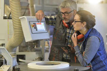 Woman in professional training, wood industrial site