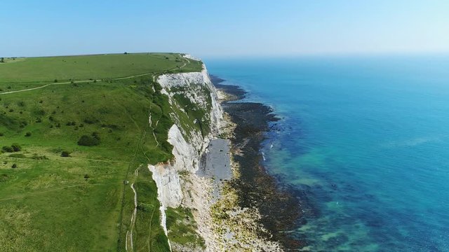 Aerial view of famous white cliffs of Dover, clear blue sky - English Channel, England, Great Britain from above, 4k UHD