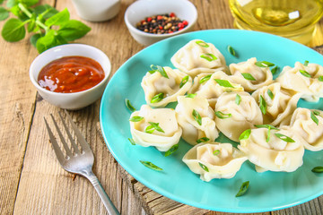 Homemade ready dumplings on an old wooden table.