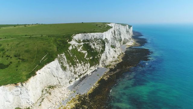 Aerial view of famous white cliffs of Dover, clear blue sky - English Channel, England, Great Britain from above, 4k UHD